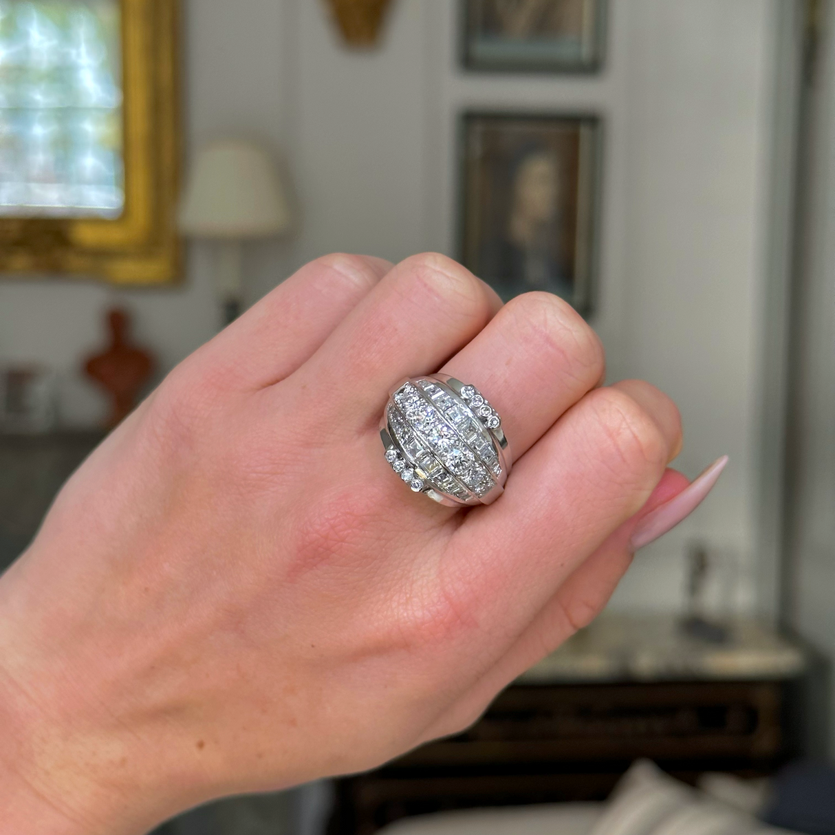 impressive Art Deco diamond bombe ring, worn on closed hand front view. 