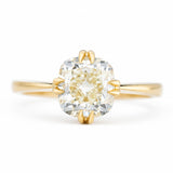 An antique-inspired, yellow-toned cushion-cut diamond solitaire ring in yellow gold.