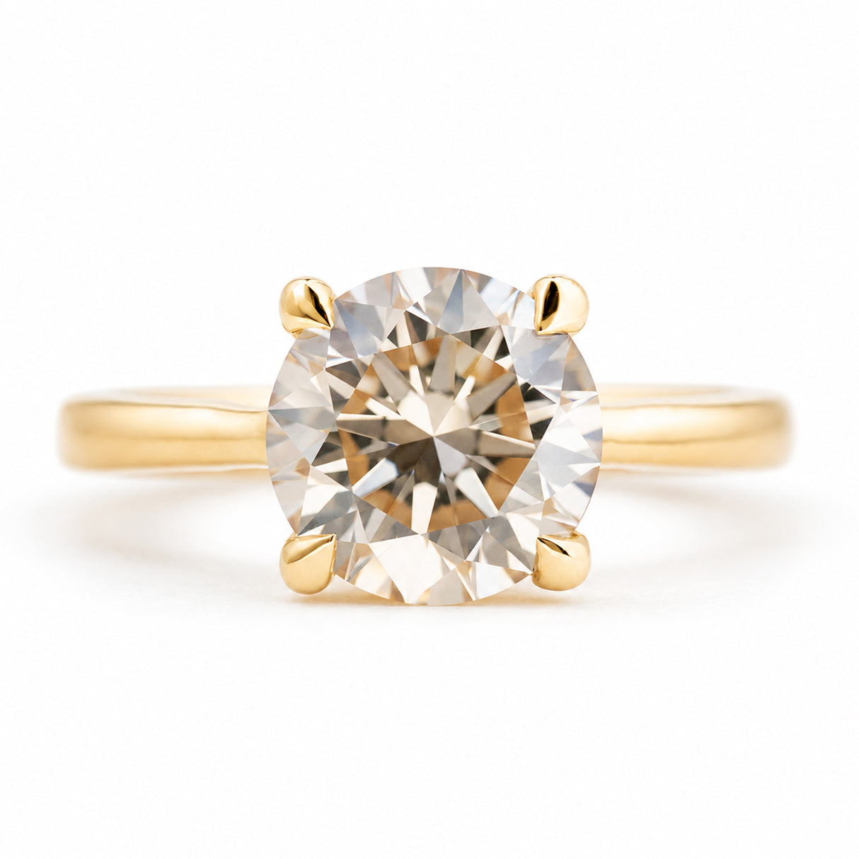 Antique-inspired, Light brown diamond solitaire engagement ring against white background
