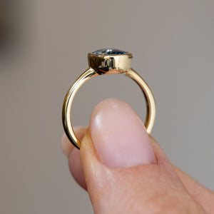 Profile view of the antique-inspired engagement ring, displaying the elevated rub-over setting and polished yellow gold shank.