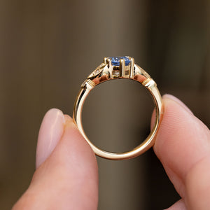 Underside profile of the vintage-inspired engagement ring, displaying the open sapphire setting and polished yellow gold shank.