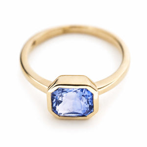 A vintage-inspired, blue sapphire solitaire yellow gold engagement ring.