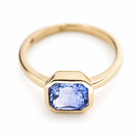 A vintage-inspired, blue sapphire solitaire yellow gold engagement ring.