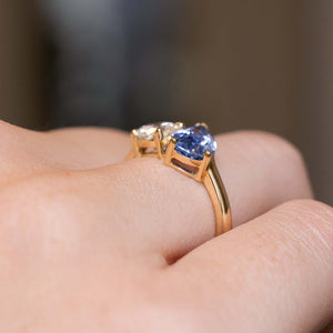 Side view of an antique-inspired Toi et Moi ring showing the claw settings