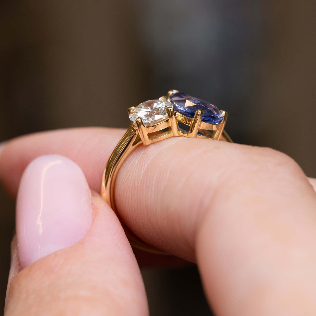 Side profile of the sapphire and diamond settings on a yellow gold band