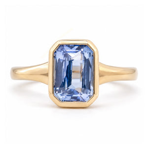 Antique-inspired sky-blue sapphire solitaire ring in yellow gold, featuring a rectangular gemstone in a smooth rub-over setting.