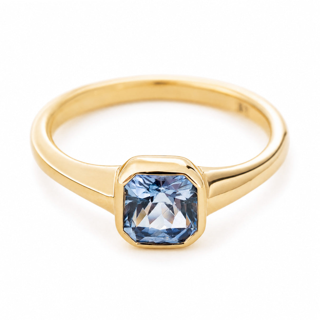 A vintage-inspired gold engagement ring with a pale blue sapphire set in 14ct yellow gold.