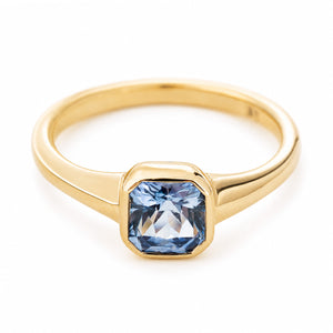 A vintage-inspired gold engagement ring with a pale blue sapphire set in 14ct yellow gold.