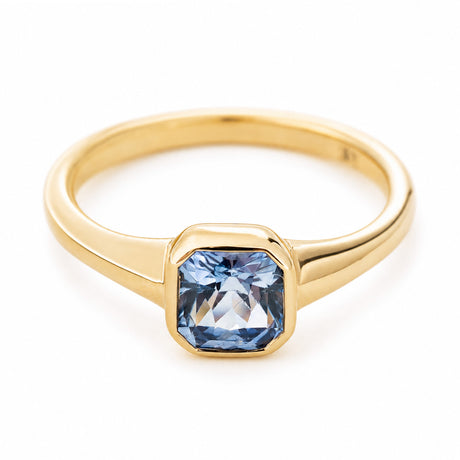 A vintage-inspired gold engagement ring with a pale blue sapphire set in 14ct yellow gold.