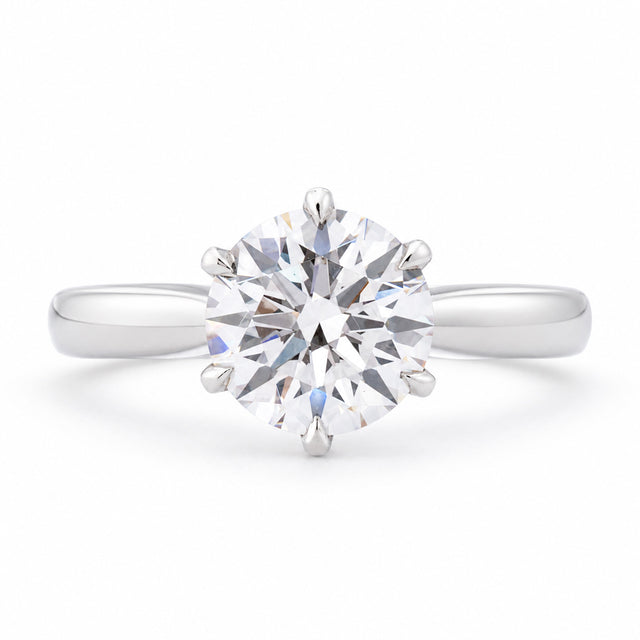 Front profile of a vintage lab-grown brilliant-cut diamond solitaire engagement ring in polished white gold.