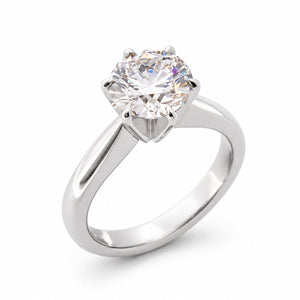 Angled product view of a vintage white gold engagement ring featuring a round brilliant-cut lab-grown diamond in a classic claw setting.