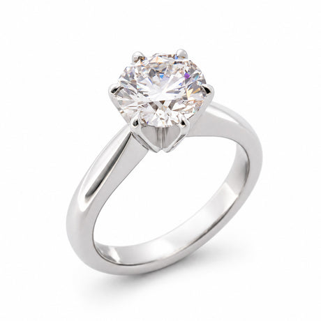 Angled product view of a vintage white gold engagement ring featuring a round brilliant-cut lab-grown diamond in a classic claw setting.
