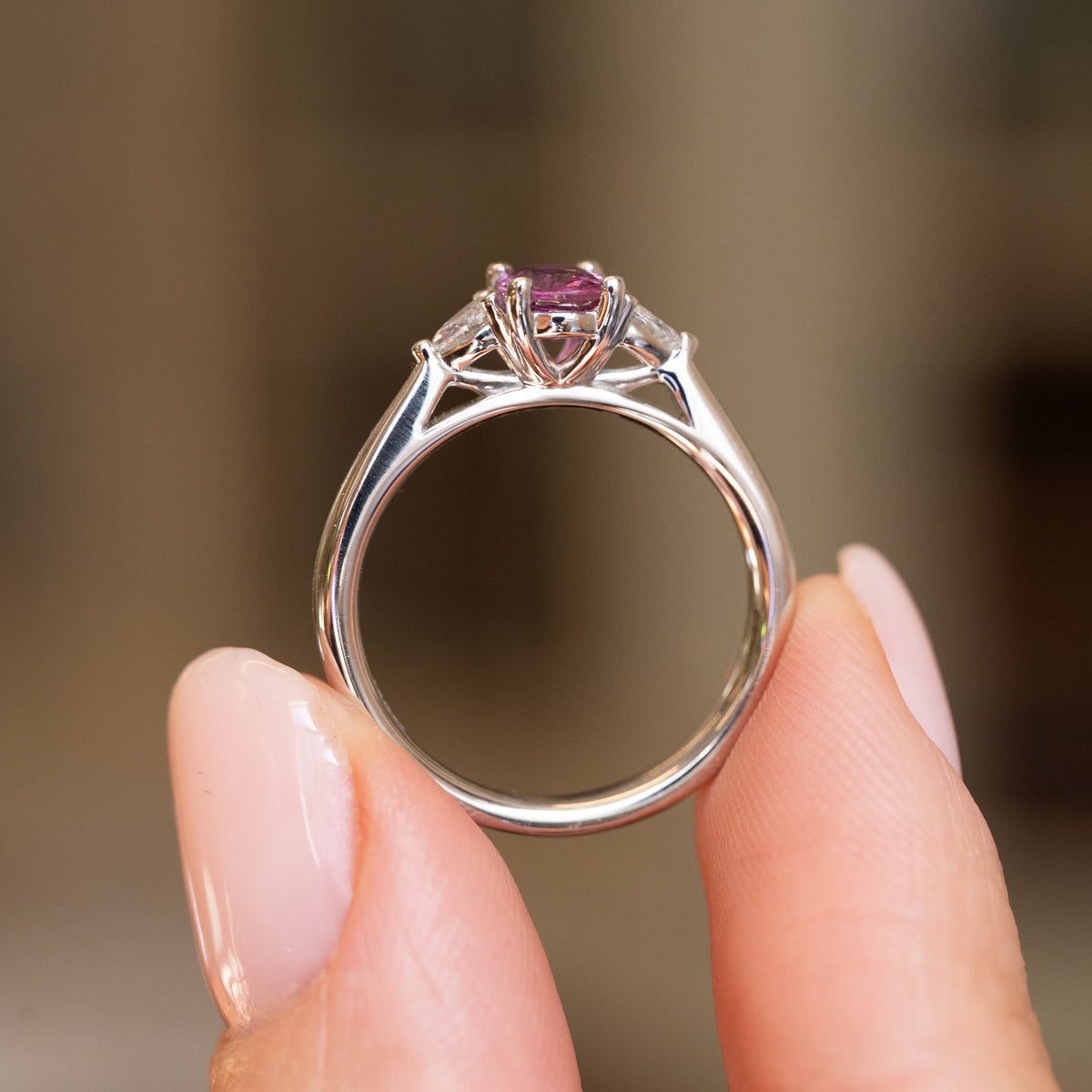 Profile view of an antique-style sapphire and diamond ring, showing the sculptural platinum gallery and polished band