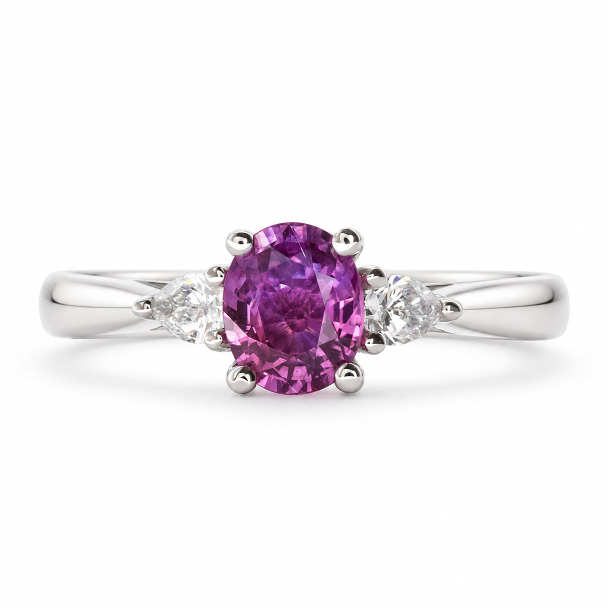 Front view of an antique-inspired three-stone engagement ring with a deep purple-pink sapphire and pear-cut diamonds in platinum.