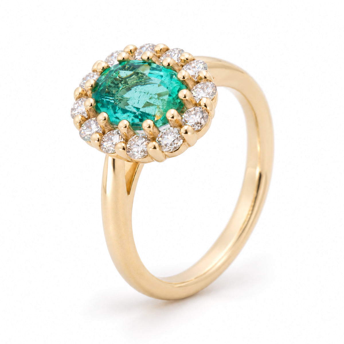 Raised studio portrait of the emerald cluster ring, revealing its vivid green centre, diamond surround and polished gold band.