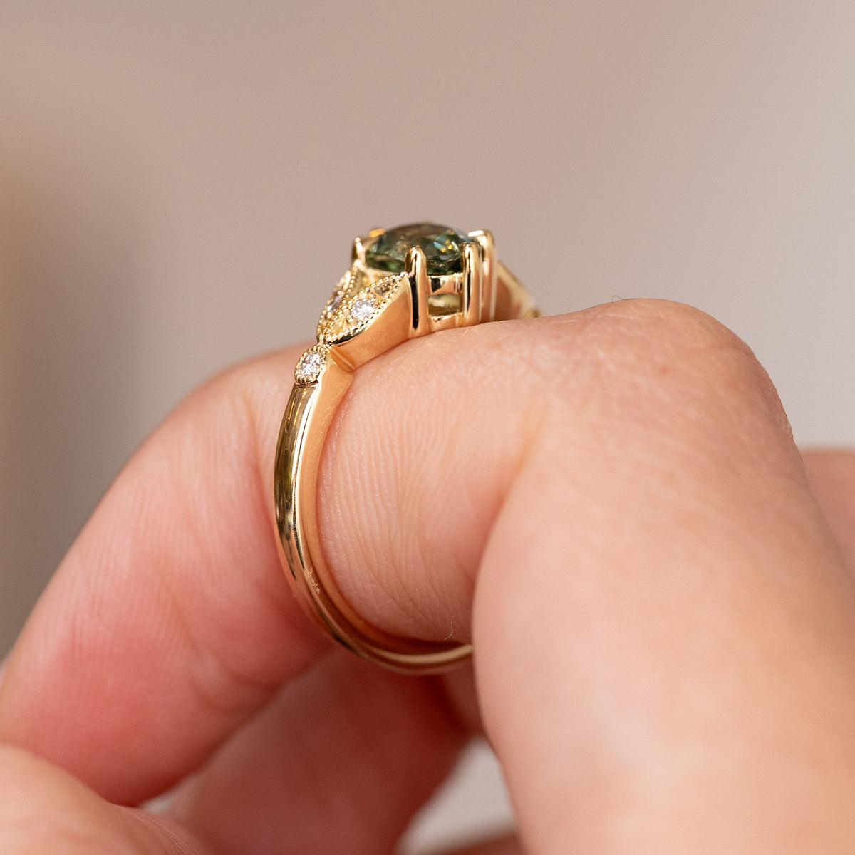 Profile of the yellow gold engagement ring, showing the elevated claw setting and gracefully tapered band.