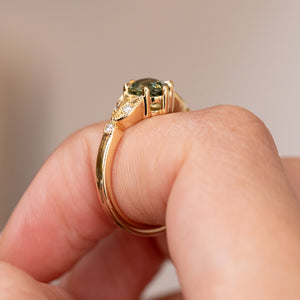 Profile of the yellow gold engagement ring, showing the elevated claw setting and gracefully tapered band.