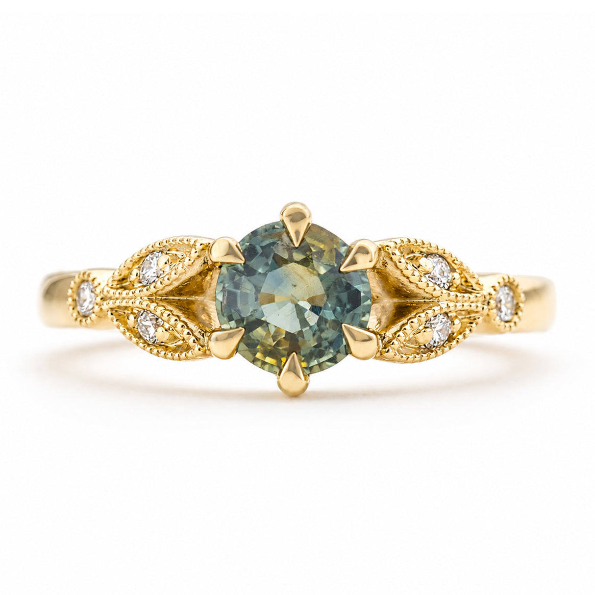 A vintage-inspired, yellow gold engagement ring featuring a central round-cut blue-green sapphire in a prong setting, flanked by decorative leaf-shaped pavé settings with diamond accent stones, shown on a white background.