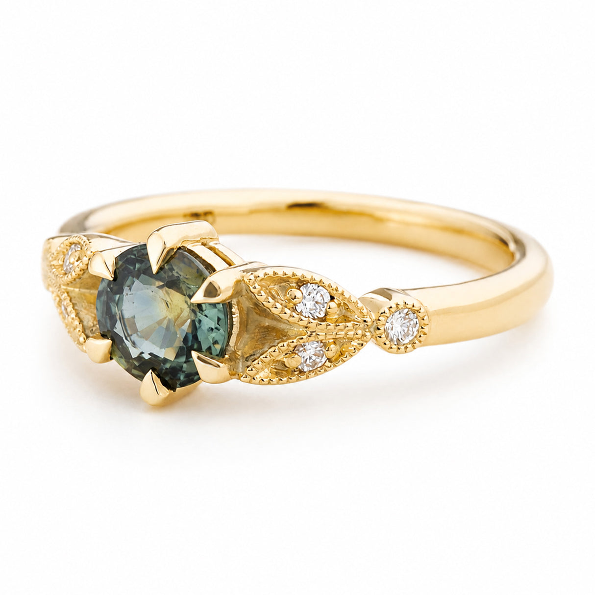 A Vintage-inspired, yellow gold engagement ring featuring a round green sapphire in a claw setting, accented by diamonds in leaf-like details on the band, set against a plain white background. 