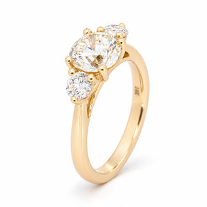 Angled view of the oval diamond engagement ring, highlighting the raised claw setting and diamond shoulders.