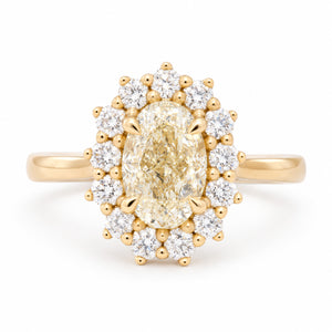 Antique-inspired yellow oval diamond cluster engagement ring surrounded by brilliant-cut white diamonds in yellow gold, front view.