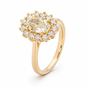 Angled view of the yellow diamond cluster ring, highlighting the raised setting and sparkling diamond halo.