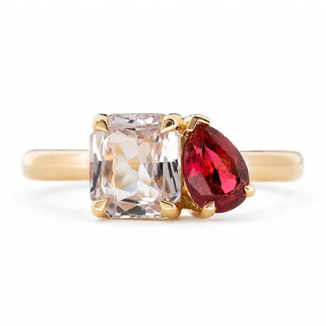 Antique-inspired, Pink sapphire and spinel Toi et Moi engagement ring in yellow gold against a white background.