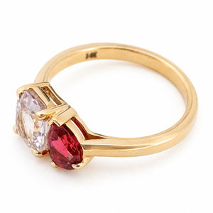 a yellow gold Antique-inspired, Pink sapphire and spinel Toi et Moi engagement ring shown from above against white backdrop