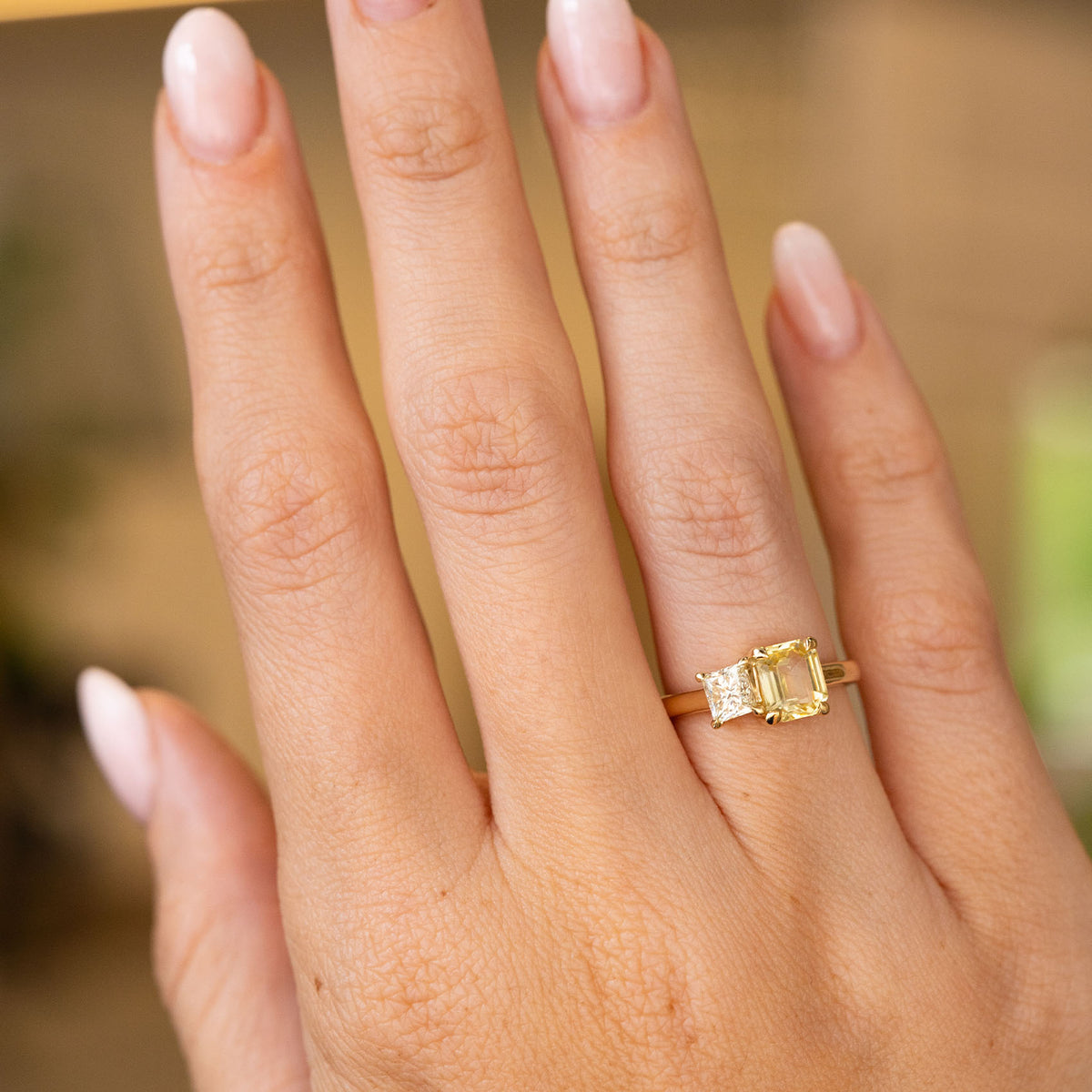 Antique-inspired, Diamond and yellow sapphire Toi et Moi engagement ring in yellow gold worn on a hand