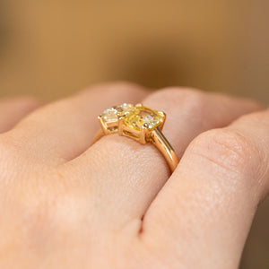 A detailed image of Antique-inspired, Diamond and yellow sapphire Toi et Moi engagement ring shown from the side when on a hand