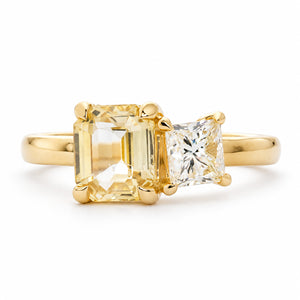 A front view of an antique-inspired, diamond and yellow sapphire Toi et Moi engagement ring in yellow gold. 