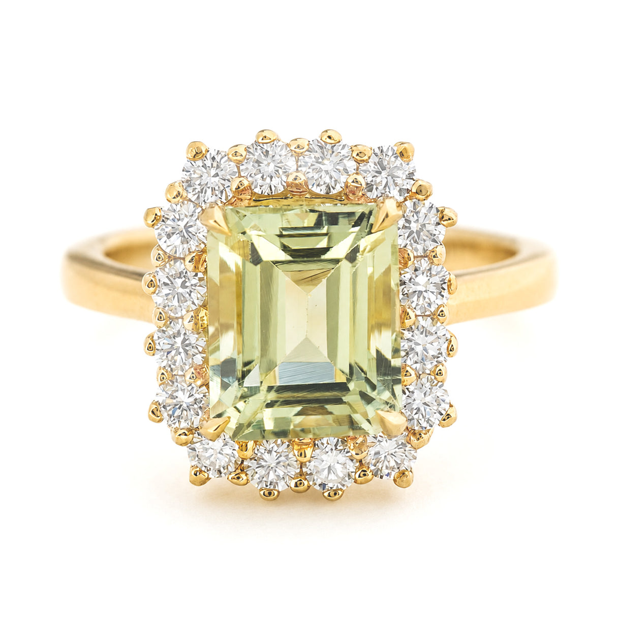 A yellow gold vintage-inspired cluster engagement ring featuring a large emerald-cut pale green beryl surrounded by a halo of diamonds, set against a plain white background.