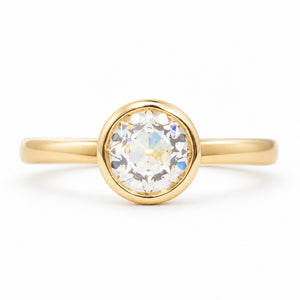 A front profile of an Antique-inspired, Old-cut diamond solitaire engagement ring set in 14k yellow gold. 