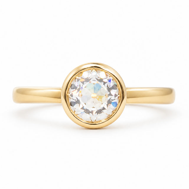 A front profile of an Antique-inspired, Old-cut diamond solitaire engagement ring set in 14k yellow gold. 