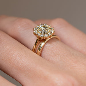 Side-angle view of the yellow diamond cluster engagement ring paired with a wedding band, showcasing its wed-fit design for a flush-fitting wedding ring.