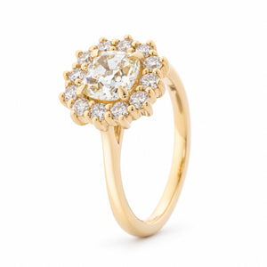 Angled view of the yellow diamond cluster ring, highlighting the raised claw setting and sparkling diamond surround.