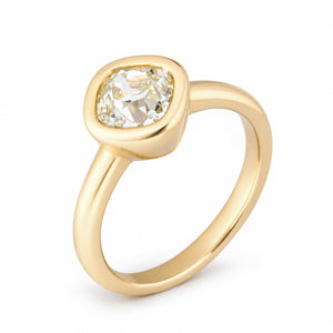 Three-quarter studio view of the old mine-cut diamond ring, showcasing its softly squared gemstone, smooth gold surround and elegant tapered band.