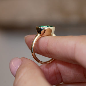 Side profile of the sea-green beryl ring, revealing the raised bezel setting and polished yellow gold band.