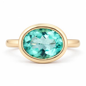 Antique-inspired sea-green oval beryl solitaire engagement ring in 14ct yellow gold, featuring a smooth bezel setting and polished gold band.