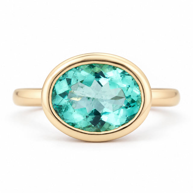 Antique-inspired sea-green oval beryl solitaire engagement ring in 14ct yellow gold, featuring a smooth bezel setting and polished gold band.