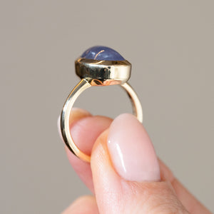 Side profile of the antique-inspired gold ring, revealing the domed sapphire, elevated bezel and simple polished band.