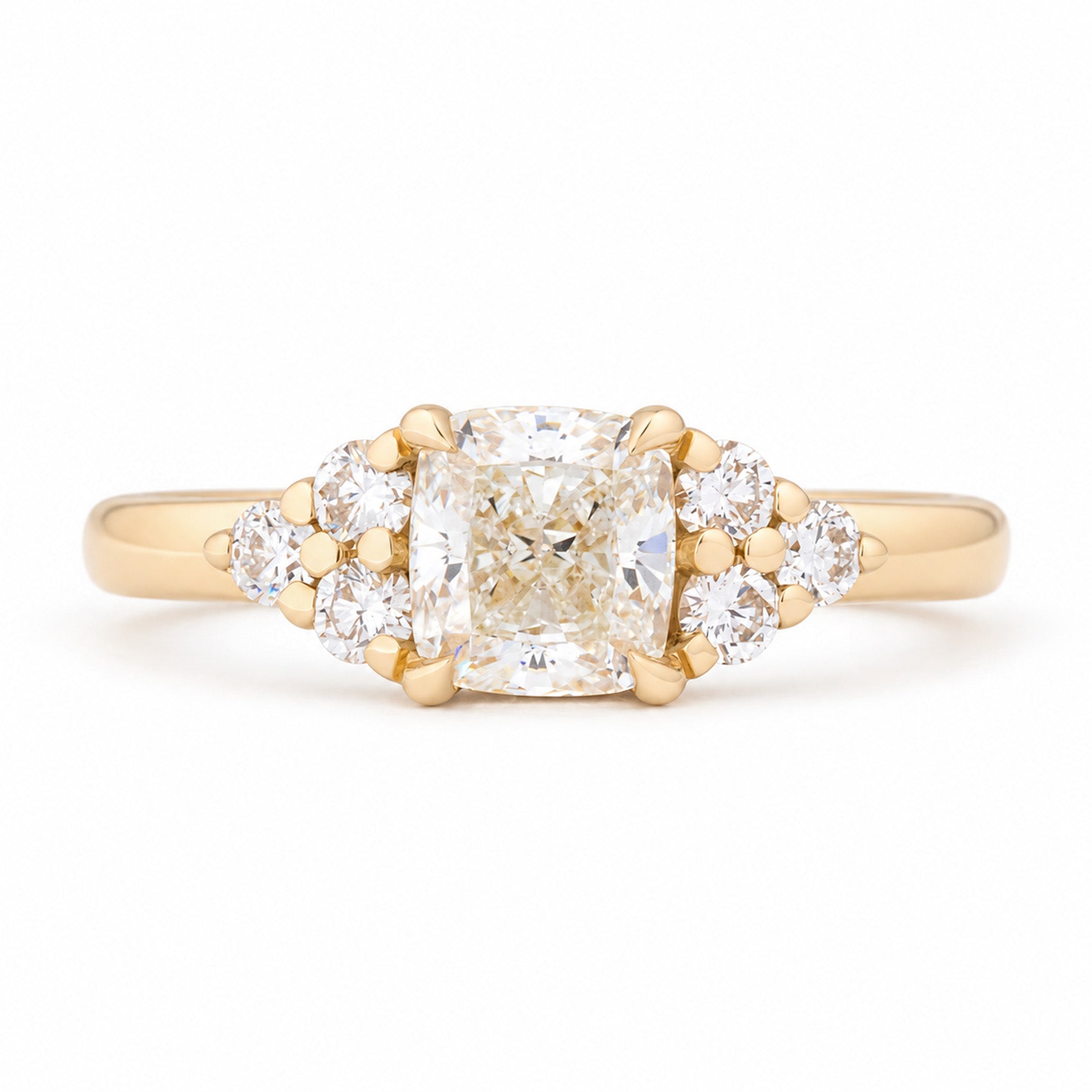 Vintage-inspired diamond cluster trefoil engagement ring in yellow gold, featuring a cushion-cut centre diamond and brilliant-cut diamond shoulders.