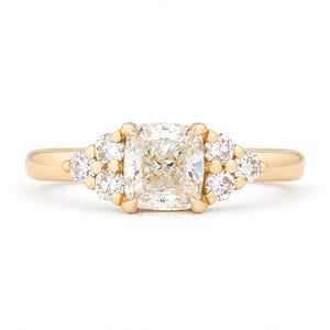 Vintage-inspired diamond cluster trefoil engagement ring in yellow gold, featuring a cushion-cut centre diamond and brilliant-cut diamond shoulders.