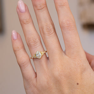 Natural hand view of the vintage-inspired ring and its delicate botanical proportions.