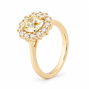 Angled view of the yellow diamond cluster ring, highlighting the raised claw setting and sparkling diamond surround.