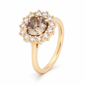 Angled view of the brown diamond cluster ring, highlighting the raised claw setting and intricate diamond halo.