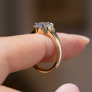 Side profile of the antique-inspired three-stone ring, revealing the claw setting and elegant yellow gold band.