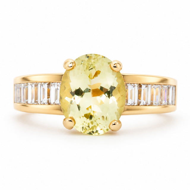 Front view of a vintage 1980s green beryl and diamond engagement ring in 18ct yellow gold, with an oval-cut centre stone and baguette diamond shoulders.