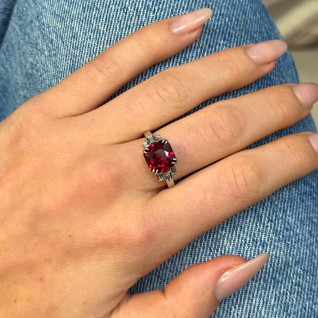 Vintage red garnet and diamond ring, worn on hand.