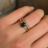 Green sapphire and diamond three-stone engagement ring stacked with wedding band